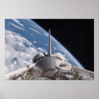 Space Shuttle Discovery backdropped by Earth