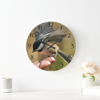 Sparrow is landing on my wife's hand Large Clock
