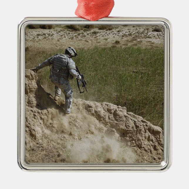 Specialist climbs down metal ornament (Front)