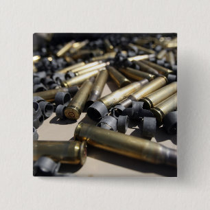 Spent brass and disintegrated links 2 inch square button
