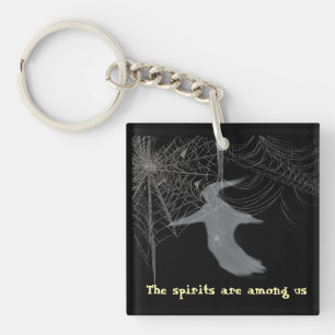 Spiders and spider webs on a button keychain