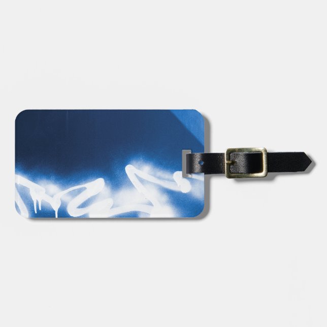 Sprayed graffiti on blue metal luggage tag (Front Horizontal)
