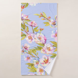 Sprigs of flowering apple or cherry trees on the b bath towel