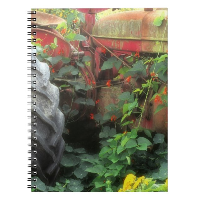 Spring flowers adorn an old tractor. notebook (Front)