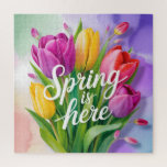 "Spring is Here" Tulip Bouquet Illustration Jigsaw Puzzle<br><div class="desc">A vibrant and cheerful digital illustration featuring a lush bouquet of tulips in shades of purple,  yellow,  and coral pink. The bouquet is overlaid with elegant,  white cursive typography that reads "Spring is here". The background consists of soft,  painterly watercolor washes in pastel green,  purple,  and peach.</div>