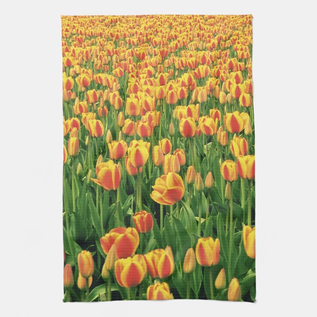 Spring tulips bloom in front of old barn. kitchen towel (Vertical)