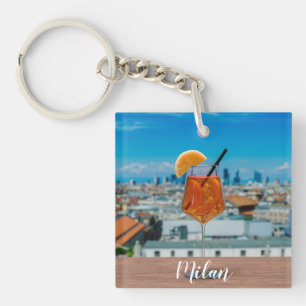 Spritz cocktail on a table with view of Milan Keychain