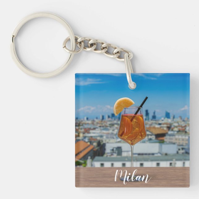 Spritz cocktail on a table with view of Milan Keychain (Front)