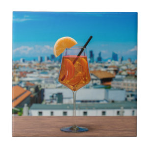 Spritz cocktail on a table with view of Milan Tile