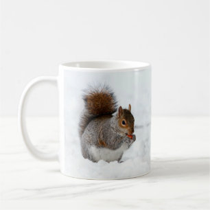 Squirrel in the Snow Eating a Red Berry Mug