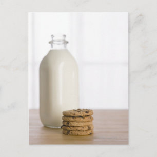 Stack of chocolate chip cookies milk in a glass postcard
