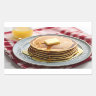Stack of pancakes on plate covered with syrup sticker