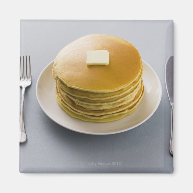 Stack of pancakes with butter on a plate magnet (Front)
