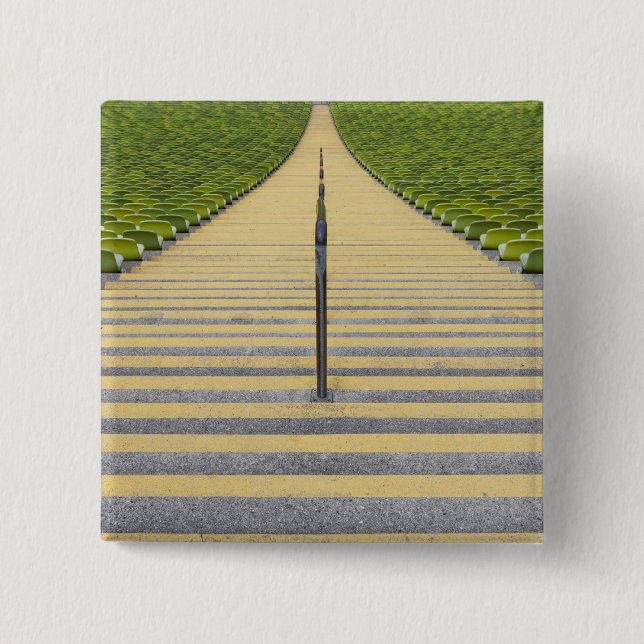 Stadium stairway between rows of green seats 2 inch square button (Front)