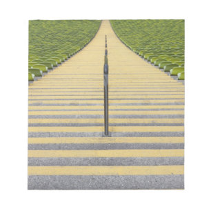 Stadium stairway between rows of green seats notepad