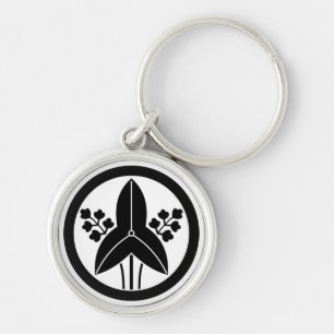 Standing arrowhead in a circle keychain