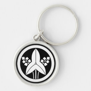 Standing arrowhead in a circle keychain