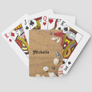 Starfish and seashells on brown beach sand playing cards