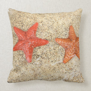 starfish on the beach, at the edge of the ocean throw pillow