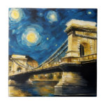 Starry Night Over the Danube Tile<br><div class="desc">Bring a touch of artistic Budapest into your space with this ceramic tile featuring a digital painting of the iconic Széchenyi Chain Bridge, gracefully spanning the Danube River. Inspired by the swirling, dreamlike style of The Starry Night, the design blends the historic elegance of Budapest with the expressive movement of...</div>