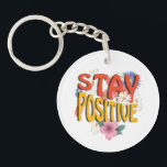 Stay Positive – Floral Motivational Keychain<br><div class="desc">Brighten your day with this uplifting design! The bold phrase STAY POSITIVE is highlighted with vibrant colors and surrounded by cheerful floral elements, making it a perfect reminder to embrace optimism and good vibes. Ideal for casual wear, workouts, or as a thoughtful gift to inspire positivity.</div>