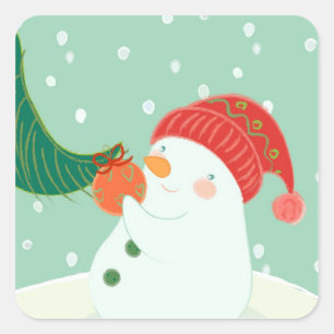 Sticker Carré Un bonhomme de neige accrochant un ornement sur un