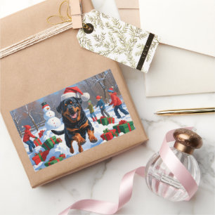 Sticker Rectangulaire Rottweiler courant dans la neige avec un chapeau d