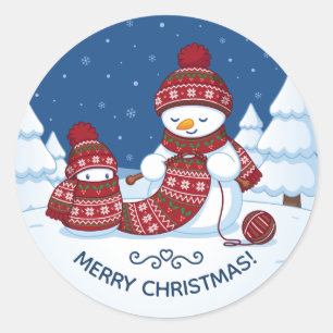 Sticker Rond Bonhomme de neige tricotant une écharpe de Noël