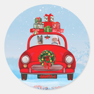 Sticker Rond Chien berger allemand en voiture avec le Père Noël