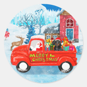 Sticker Rond Chien teckel dans un camion de livraison de Noël e