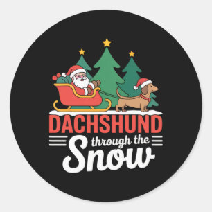Sticker Rond Dachshund à travers la fête des neiges Père Noël