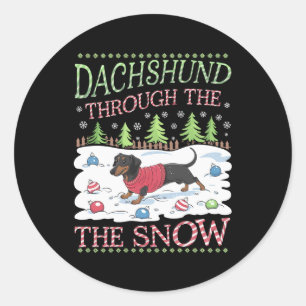 Sticker Rond Dachshund à travers la neige