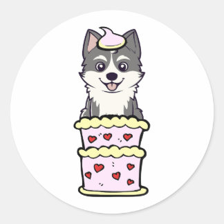Sticker Rond Drôle husky sautant d'un gâteau