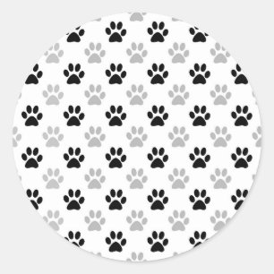 Sticker Rond Empreintes de pattes de chiots noirs et blancs