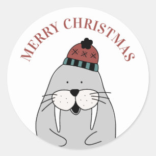 Sticker Rond Joyeux Noël. Joli morse d'hiver. Animal drôle