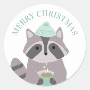 Sticker Rond Joyeux Noël. Raton laveur d'hiver. animal mignon