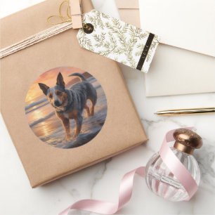 Sticker Rond Sandy Paws Australian Cattle Dog on Beach Sunset