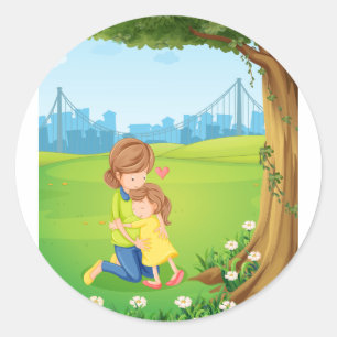 Sticker Rond Une mère étreignant sa fille sous l'arbre
