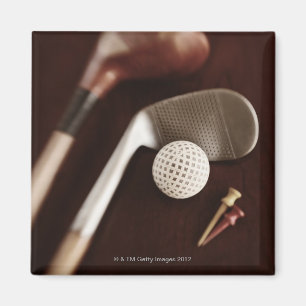 Still life if vintage golf clubs, tees and ball. magnet