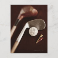 Still life if vintage golf clubs, tees and ball.