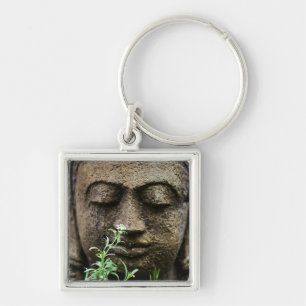 Stone garden statue with flower keychain
