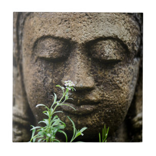 Stone garden statue with flower tile