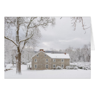 Stone mansion in snow with hills