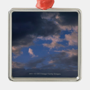 Storm clouds against blue sky metal ornament