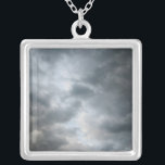 Storm Clouds Breaking Silver Plated Necklace<br><div class="desc">Dark stormy clouds are breaking apart in the foreground of this colour photograph. The cloud layers become lighter shades of grey deeper into the image. Hints of light blue sky are visible beyond the storm clouds as the weather starts to clear up. Digital, colour photograph. Copyright © 2010 Claire E....</div>