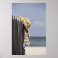 Straw Hat Hanging On Fence At Beach