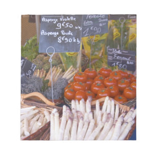Street market merchant's stall with white notepad