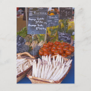 Street market merchant's stall with white postcard