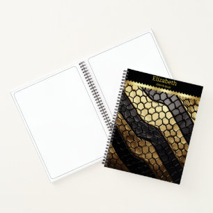 Striking patterns of a black and gold snake skin notebook