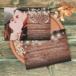 String Lights Rustic Wood Photo All In One Wedding Invitation<br><div class="desc">A rustic wedding invitation featuring pretty string lights and a delicate hand-drawn rustic floral garland of botanical leaf foliage with stylish script typography,  on a rustic wood background. Personalize with all your special wedding day information on the reverse including your RSVP,  accommodation,  and additional details. Designed by Thisisnotme©</div>